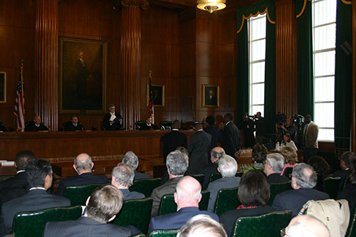 Chief Justice Sarah Parker administers the oath to Justice Beasley as her family looks on